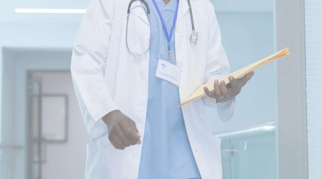 clinician wearing lab coat with files