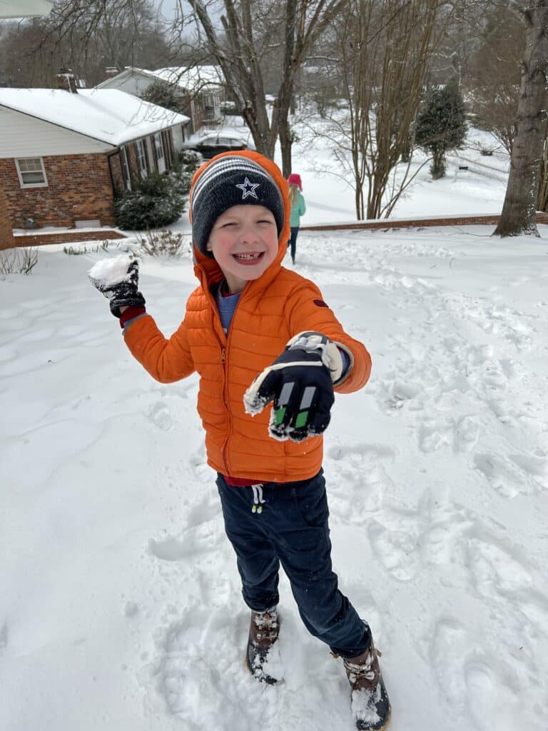 photo of child with snowball